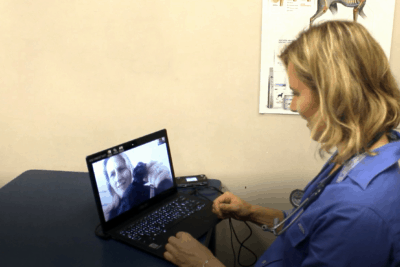 Dr Leigh consults with a client about her dog's foot in a telehealth consult. 