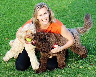 Dr Leigh Davidson with two cavoodle friends